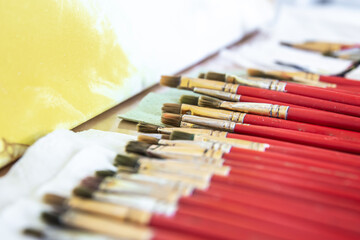 Obraz premium A set of red brushes for painting, close-up.