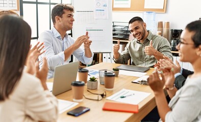 Group of business workers smiling and clapping to partner at the office.