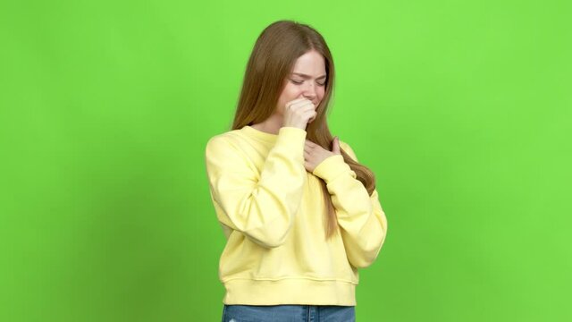 Teenager girl is suffering with cough and feeling bad over isolated background. Green screen chroma key