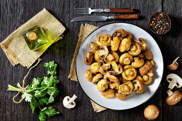 grilled juicy mushrooms on a plate, top view