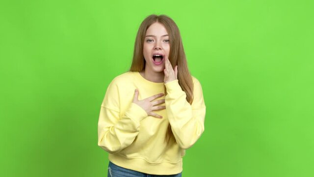 Teenager girl gaping because have just surprised with a gift over isolated background. Green screen chroma key