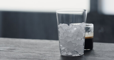 making espresso tonic on black wood table