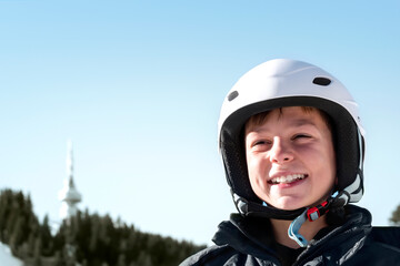 Winter ski vacation in mountains resort, alpine skiing concept. Smiling happy child skier in ski...