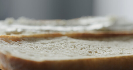 cream cheese on fresh baguette slice to make sandwich closeup