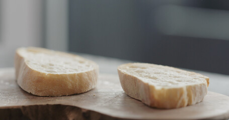 slices of rustic ciabatta on olive wood board