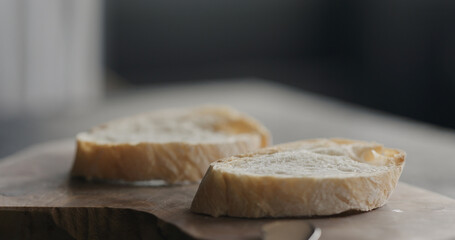 slices of rustic ciabatta on olive wood board