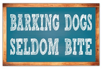 BARKING DOGS SELDOM BITE words on blue wooden frame school blackboard