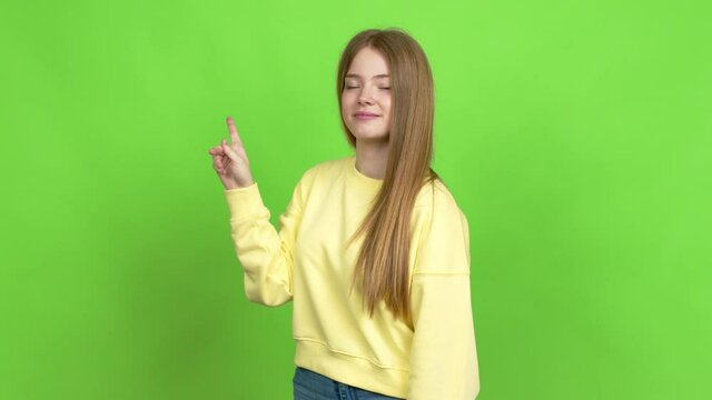 Teenager girl doing NO gesture over isolated background. Green screen chroma key