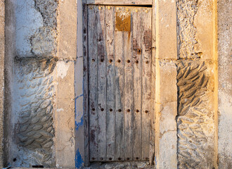 Aged and rustic wooden door in an abandoned house.