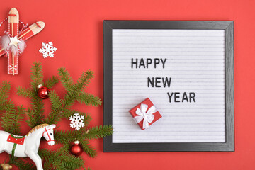 Felt board with the inscription happy new year on a red background.