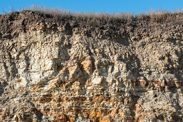 Fototapeta premium soil layers and rock of land cross. Rock stone crosssection side background. rock carrier mountains closeup. For indicate the layers of soil and rock