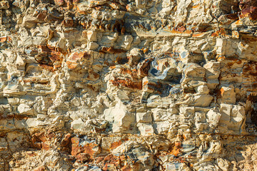 volcanic stone texture. Rock stone side background. White clay rock carrier mountains closeup. For indicate the layers of soil and rock.