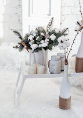 Christmas bouquet of spruce and cotton in a white interior