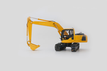 Yellow excavator on a white background ,bucket holder on the floor