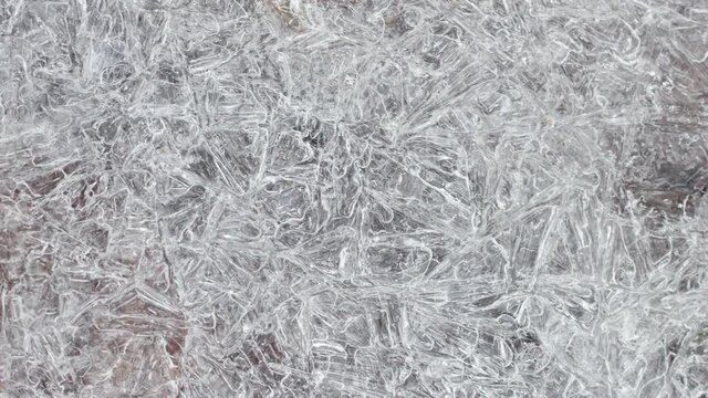 cracked ice surface texture closeup top view, natural background, frozen water surface