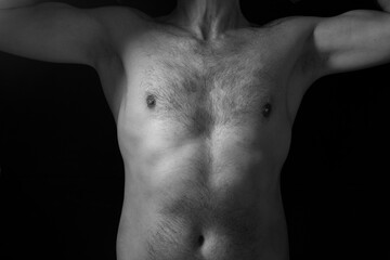 Black and white photo of haory male chest arms raised