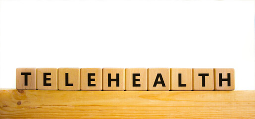 Time to telehealth symbol. Wooden cubes with the word 'telehealth'. Beautiful wooden table, white background, copy space. Business, medical and telehealth concept.