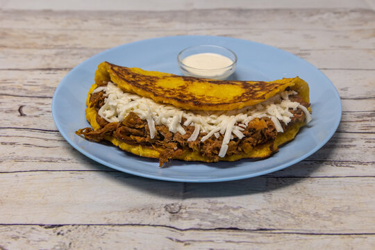 Closeup shot of traditional Cachapa with meat and cheese