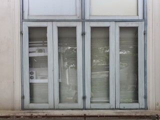 vintage shape glass hinged window with wooden frame It is an antique window that is popular in old-fashioned buildings.
