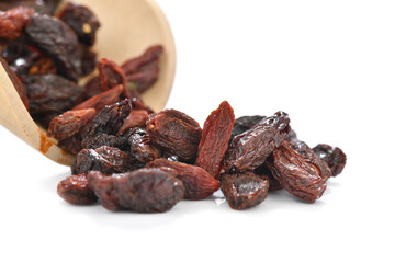 Close-up of dried goji berries in wooden spoon over white background
