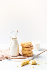 Freshly baked homemade honey cookies with milk for breakfast on a white background