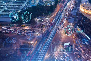 Information flow hologram over night busy road traffic in Bangkok. The largest technological center in Southeast Asia. The concept of programming science. Double exposure.