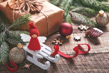 Funny Christmas Angel fir tree branches and gift boxes on winter snowy background with snowy branches. Christmas or Winter concept.