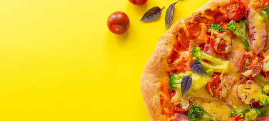 Homemade pizza on a yellow background. View from above. Free space for your text.