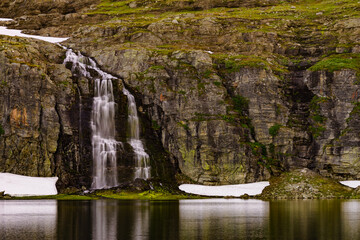 Fototapeta na wymiar Mountain lake waterfall Flotvatnet Norway