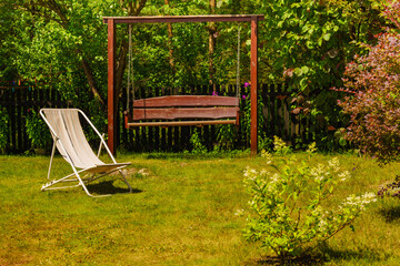 Garden with deck chair and swing