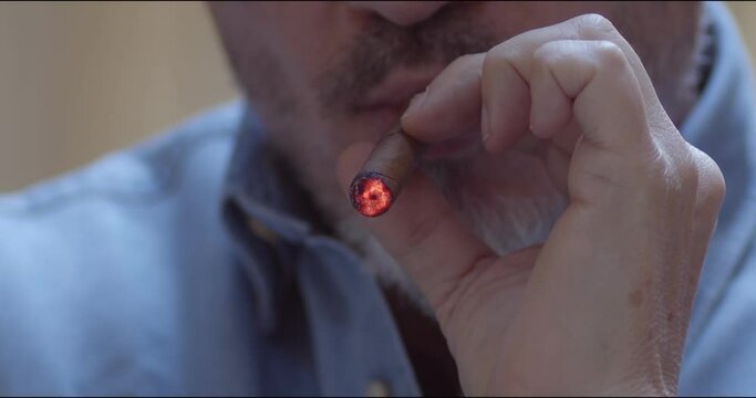 Man smoking cigar - slow motion close up video. Copy space.