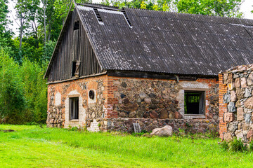 Fototapeta na wymiar Old farm house with stone walls and wooden roof