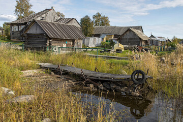 View of a small pier at an abandoned village house on the shore of the bay of Lake Ladoga - obrazy, fototapety, plakaty