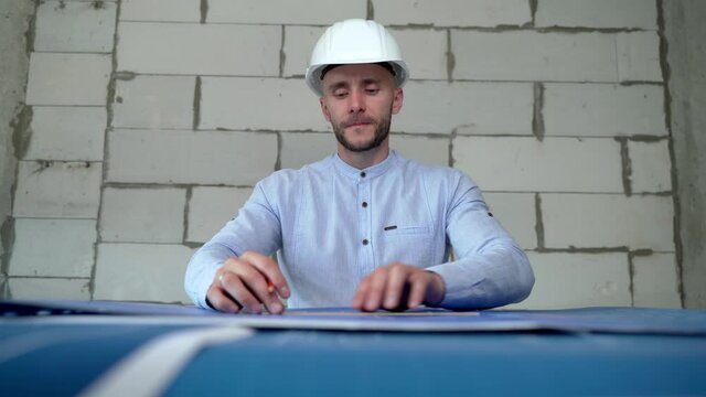 An architect makes amendments to the layout of the building