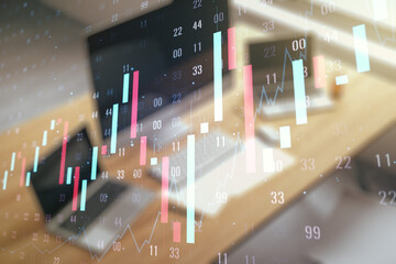 Abstract creative financial graph and modern desktop with computer on background, forex and investment concept. Multiexposure