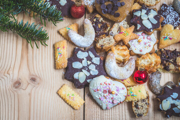 Obraz na płótnie Canvas Homemade Christmas cookies: Delicious cookies, powdered sugar and Christmas bauble on rustic wooden table