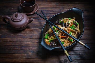 Asian style- restaurant background. Udon noodles with beef Wok