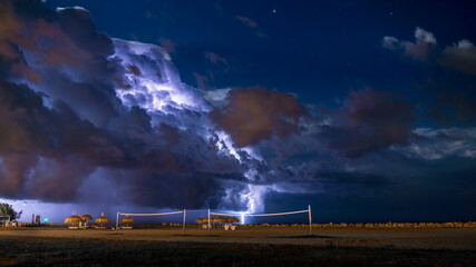 View of Thunder from Large Storm on a Beach Volleyball Court