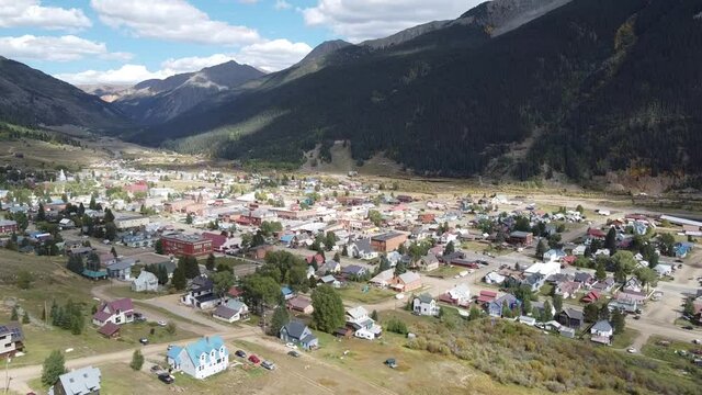 Aerial over iconic mining town of Silverton in Colorado surrounded by majestic mountain ranges