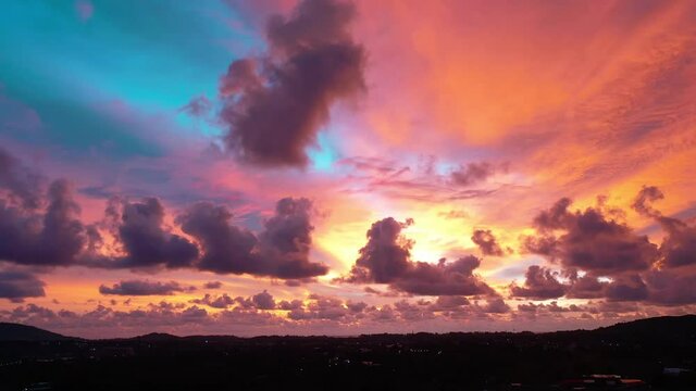 Scene of Colorful romantic red sky sunset with Changing the color of the sky background. .beautiful large red cloud at sunset above Phuket city..beautiful red sky at sunset nature and travel concept