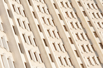 minimalist facade of a skyscraper with a symmetrical pattern of windows