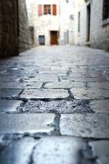 Obraz premium Narrow cobblestone street in the old town. Kotor, Montenegro. Close-up. Selective focus.