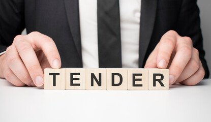 Man made word tender with wooden blocks. Business concept.