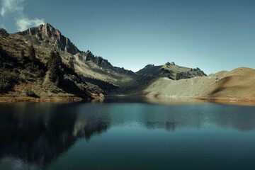 Naklejka premium Lac De Lessy and Mountain landscape at sunrise in The Grand-Bornand, France