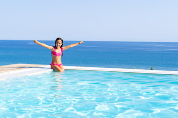 Young girl posing near swimming pool