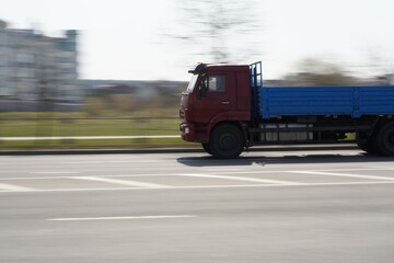 Photo of a truck that drives on the road in the city