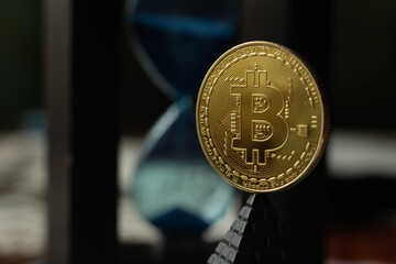 Bitcoin coin close up on hourglass background