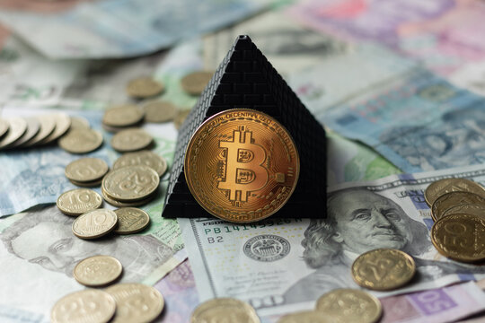 Bitcoin, pyramid, US dollars and coins