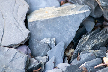 Fototapeta premium Raw rocks and minerals as natural stones background with crushed and rough material at a rough coast or rocky beach show nuggets and sandstones in harmonic pastel colors as natural mineral background