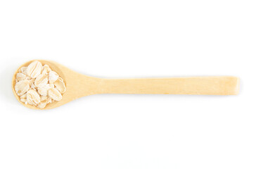 Top view of dry rolled oatmeal in wooden spoon isolated on white background.